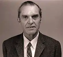 Head and shoulders of elderly man in suit and tie