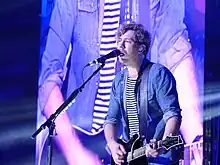 Bourne performing with Busted at Manchester Arena, 2016