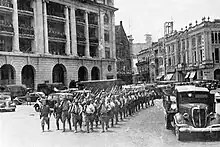 Army column marches through urban area