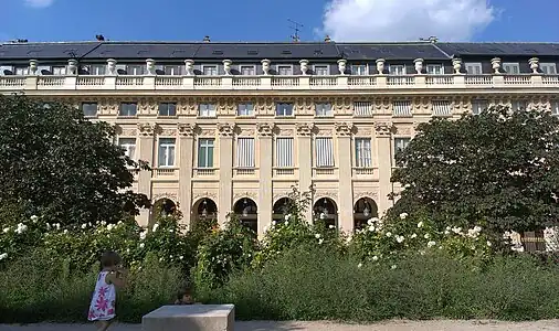 Unified façade of town houses overlooking garden