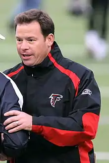 Man wearing black jacket with a red stripe