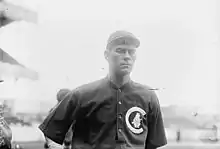 A man in a baseball uniform is shown from the waist up.