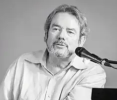 A black and white photo of the track's writer and producer, Jimmy Webb.