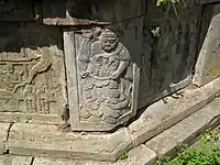 The corners of the pagoda display dour guardian telamons such as this, that symbolically hold up the entire structure