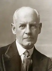 white man, clean-shaven, hatless, balding, in late middle age looking at camera