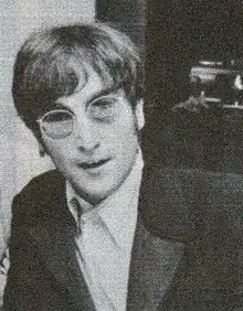 A head and shoulders picture of John Lennon, wearing sunglasses