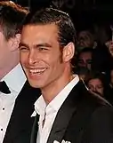 Kortajarena smiling towards the camera, wearing a black coat