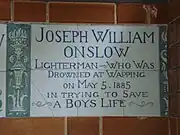 A tablet formed of six standard sized tiles, bordered by green flowers in the style of the Arts and Crafts movement