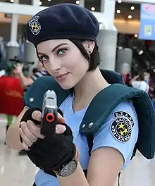 Photograph of Voth in a blue police uniform pointing a toy gun at the viewer.