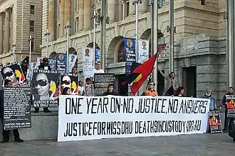 A group of demonstrators with a banner outside a public building