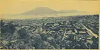 The city covered deep in ash after the 1914 eruption of the Sakurajima volcano which is seen in the distance across the bay