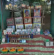 Another non-government vendor outside the temple, selling liquor, flowers and framed photographs