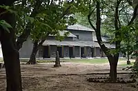 Kalo Bari – the house built with mud and coal tar. Click on the pic to enlarge for a glimpse of the wall decoration.