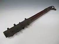 A small antique Japanese wooden club with iron-covered ends and iron studs (ararebō)