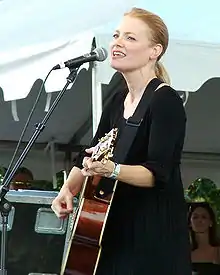 Willis playing guitar at a microphone