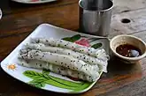 A variation of the Thai khao phan with black sesame seeds and served with a spicy dipping sauce called nam chim chaeo