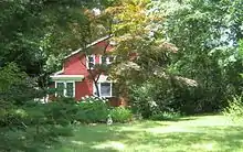 a red house set in the forest