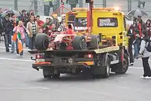 Räikkönen's damaged F2008 is brought back to the pits after the Finn crashed with two laps to go in the 2008 Belgian GP.