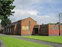 Brick church with a lawn