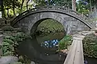 A full circle forms due to the shape and reflection of Engetsu-kyō stone bridge at Koishikawa-Kōrakuen in Tokyo, Japan