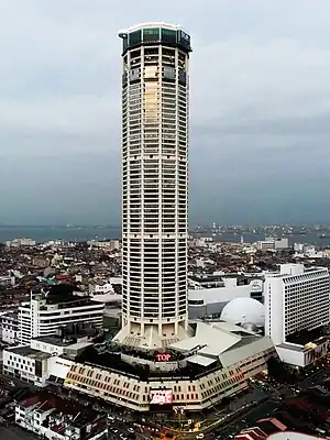 Komtar Tower, with the podium visible below and surrounded by low-rise buildings.