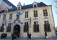 A yellow brick building with a blue roof.