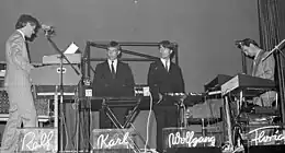 The five members of the electronic band Kraftwerk performing on a stage