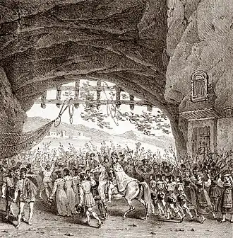 Drawing of a crowd scene on a theatre stage, with man in robes on horseback at the centre