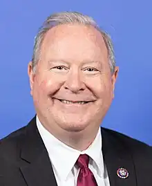 Bucshon smiling, wearing a suit