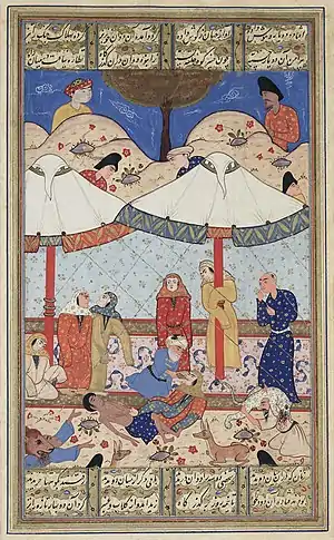 A scene from the romance "Layla and Majnun". The thwarted lovers meet for the last time before their deaths.  Both have fainted and Majnun's elderly messenger attempts to revive Layla while wild animals protect the pair from unwelcome intruders.  Late 16th-century illustration.