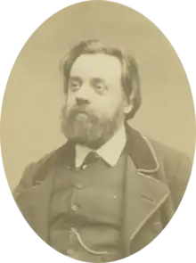 Portrait photograph of Gustave Lefrançais, wearing a beard and a neat suit