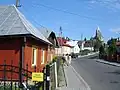 gothic parish church built in 1539 by the Kmita family and small street in Lesko