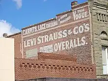 photo of a sign advertising Levi Strauss & Co. painted on a brick wall in Woodland, California