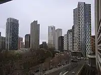 The emerging cluster in Lewisham also known as Lewisham Gateway, and first Borough of Sanctuary, which includes 209 Connington Road Tower at 117m tall which is the white building in the centre and Lewisham Exchange at 105m tall to the left of it. All of the high-rises shown in this picture are residential with the exception of the grey building shown in the immediate right foreground which was formerly the London offices of Citigroup until they relocated to 25 Canada Square at Canary Wharf in 2001