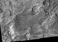 Libya Montes Region, as seen by HiRISE. Image contains some sheer rock cliffs.