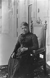 Queen Liliʻuokalani, seated inside ʻIolani Palace