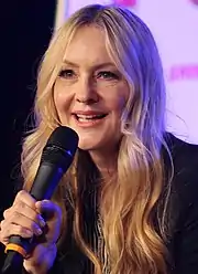 Image of actress Linda Larkin, speaking voice of Princess Jasmine, addressing an unseen audience at a convention.