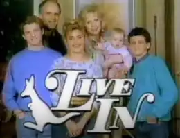 The words "Live In" in a capitalized, white-colored display typeface. A white kangaroo outline is present to the left of the words and the show's main cast smiles behind.