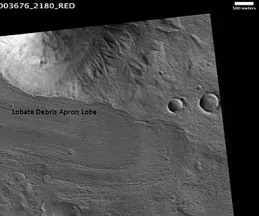 Lobate debris apron in Phlegra Montes, as seen by HiRISE. The debris apron is probably mostly ice with a thin covering of rock debris, so it could be a source of water for future Martian colonists. Image from the Cebrenia quadrangle. Scale bar is 500 meters long.