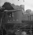 An IC steam locomotive taking on coal at a Chicago rail yard in November 1942