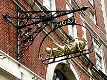 Gresham's initials "TG" and date 1563 with his golden grasshopper emblem, serving as the sign of a bank in Lombard Street, the historic centre of banking in the City of London