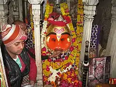 Liquor being offered to the deity