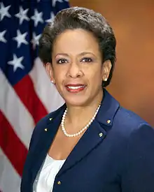 Lynch smiling in front of an American flag