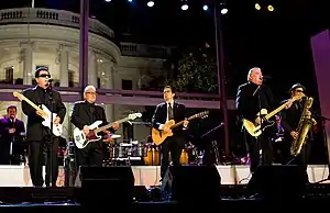 A band is performing at a stage in front of the White House