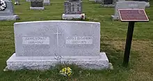 Large rectangular grey granite stone inscribed with names, birth years, and death years, of St. Laurent and his wife