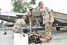 Louisiana National guard loading supplies on a boat