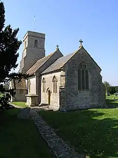 Stone building with square tower.