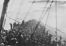 The crew of the sinking Zuikaku salute as the flag is lowered on 25 October 1944.