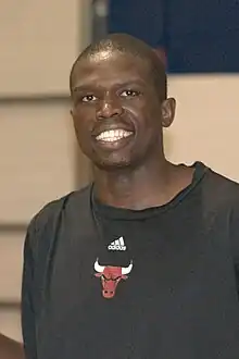 Deng smiling in the Bulls' black warmup uniform