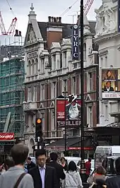 Street scene with front of theatre, showing a banner for Thriller – Live